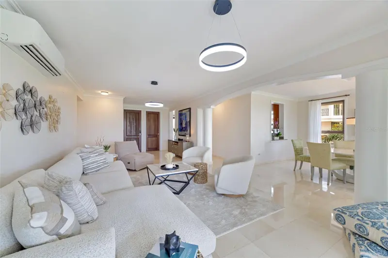 Bright living room with white marble floors and soft seating